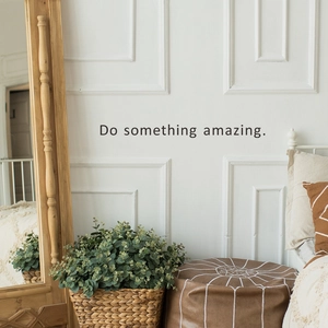 Inspirational Do Something Amazing wall decal on a modern white living room wall