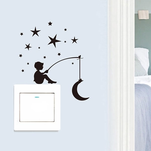 Detailed view of child fishing for moon silhouette sticker on a light blue wall switch
