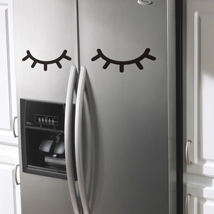 Minimalist black eyelash wall stickers for refrigerator decor in a modern white kitchen