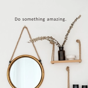 Golden round mirror and wooden wall shelf with inspirational quote wall sticker decor