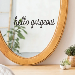 Detail of hello gorgeous vinyl sticker applied on a mirror for home wall decoration