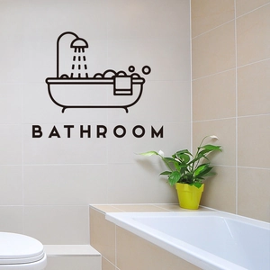 Minimalist black bathtub wall sticker with bathroom lettering on beige tile surface