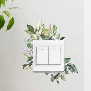 Watercolor green leaves and flower wall sticker around a double toggle switch panel