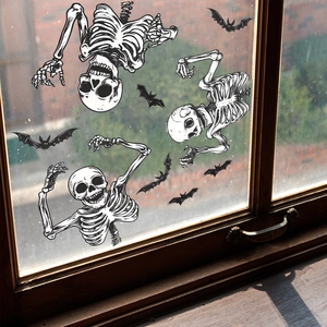 Halloween static window clings featuring skeleton and bat decals on a wooden window pane