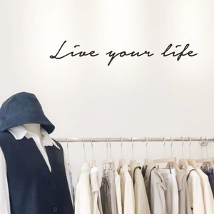 Navy blue sleeveless vest with white shirt and matching bucket hat in minimalist store setting