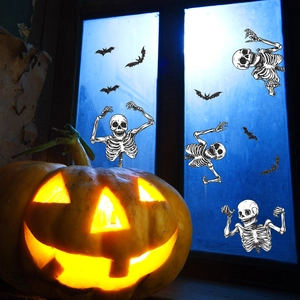 Halloween window stickers featuring skeletons and bats with a glowing pumpkin lamp