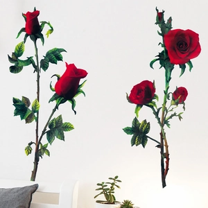 Romantic red rose wall decals for home decor shown on a white wall in a cozy living room setup