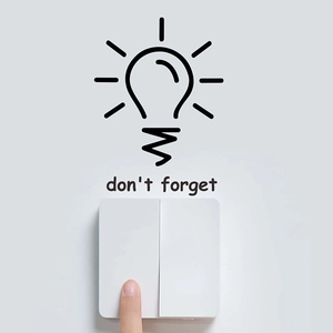 Minimalist white wall switch with Don't Forget light bulb decal on grey wall
