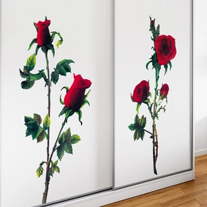 Detail view of red rose wall decals with realistic green leaves on a white wardrobe door