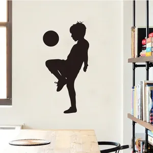 Soccer boy silhouette wall decal for kids room featuring an athlete juggling a football