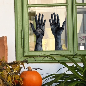 Creepy Halloween demon arm window cling with realistic skin texture and sharp black nails