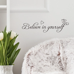 Minimalist 'Believe in yourself' wall sticker with heart accents on a white wall