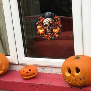 Halloween static window cling featuring a skull, pumpkins, and maple leaves in a round design