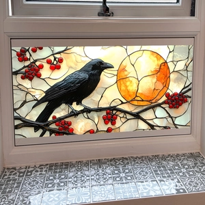Artistic stained glass suncatcher with a black raven on a moonlit branch with berries