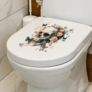 Detail of toilet lid sticker featuring gothic skull floral and butterfly art