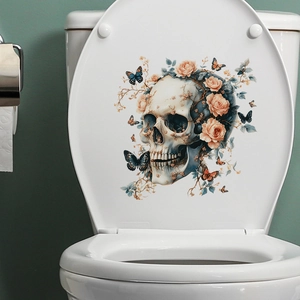 Close-up of a skull with roses and butterflies decal on a white toilet lid cover