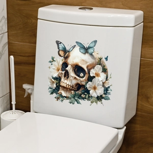 Detailed view of skull and flower decal applied to a white ceramic toilet tank surface