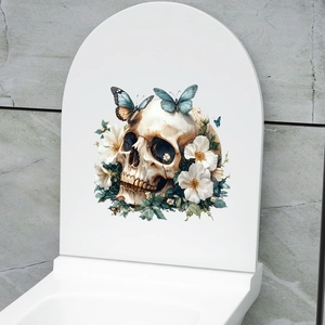 Detailed view of floral skull and butterfly decals on a white closed toilet lid cover