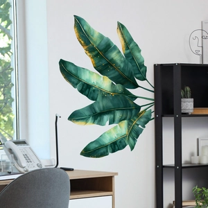 Tropical monstera and banana leaf wall stickers with gold details in home office setting