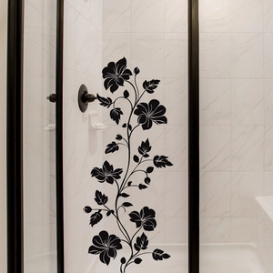 Detail of black floral vine wall decal applied on white marble bathroom tiles