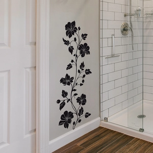 Vertical black floral vine wall decal applied to a modern bathroom wall background