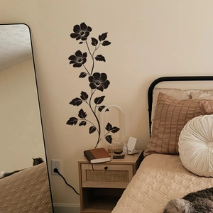 Elegant black floral wall stickers with vine patterns in a cozy minimalist bedroom setting
