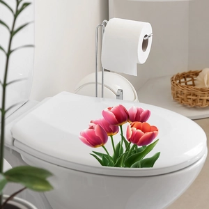 Detailed view of pink tulip floral stickers applied on a white bathroom toilet lid