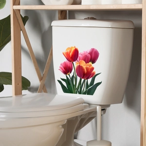 Detail of realistic red and pink tulip decals applied on a white ceramic toilet tank surface
