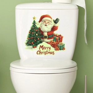 Close-up of Santa Claus and Christmas tree luminous stickers on a white toilet tank