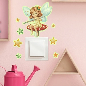 Luminous fairy on mushroom and stars stickers around a white wall light switch