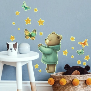 Detailed view of luminous watercolor bear and butterflies wall stickers in a nursery setting