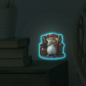 Glow-in-the-dark wall sticker featuring a cartoon mouse reading on a chair at night