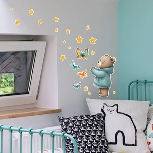 Detailed view of watercolor night light bear and butterfly wall decals in a cozy nursery
