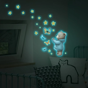 Glow in the dark wall decals showing a cute bear and butterflies in a dark kid bedroom