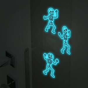 Luminous Halloween skeleton wall stickers glowing bright blue on a dark indoor wall