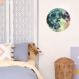 Luminous moon and galaxy wall sticker displayed in a cozy bedroom setting