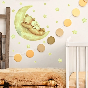 Luminous wall sticker showing a sleeping bear and rabbit on a moon with glowing stars