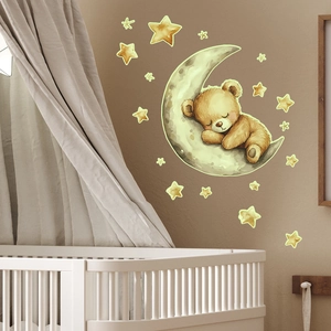 Detailed view of luminous sleeping bear and stars wall stickers in a cozy nursery setup