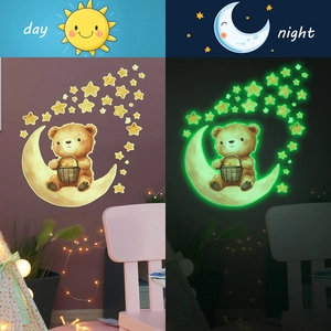 Luminous wall sticker featuring cartoon bear on moon with glowing stars in day and night view