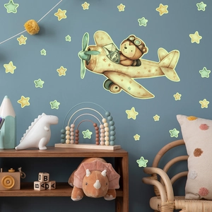 Leuchtender Wandsticker mit fliegendem Bären im Flugzeug und Sternen für das Kinderzimmer