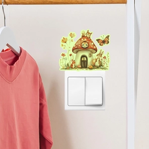 Glow-in-the-dark mushroom house and forest animal sticker applied on a white wall switch
