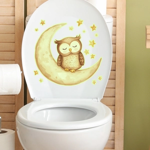 Glow in the dark owl and moon toilet seat sticker with stars on white ceramic lid
