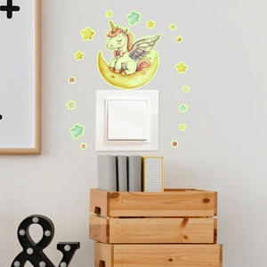 Luminous unicorn and yellow moon wall stickers applied above a light switch in a kids room