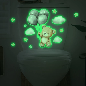 Glow-in-the-dark toilet stickers featuring cartoon bear and stars in dark bathroom