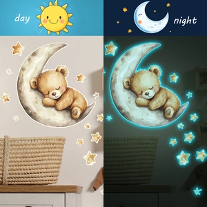 Luminous wall stickers featuring a sleeping brown bear on the moon with glowing stars