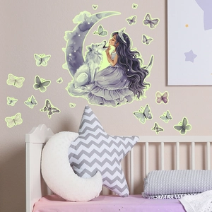 Detail of glow-in-the-dark wall stickers with wolf, moon, girl and butterfly motifs