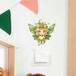 Close-up of a luminous forest elf wall sticker applied above a white light switch
