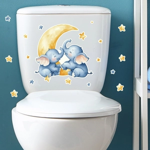 Detail of cartoon elephants and moon glow-in-the-dark wall stickers on white surface