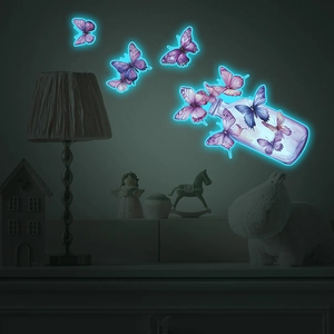 Glow-in-the-dark butterfly wall stickers showing luminous effect in a dark bedroom