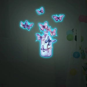 Luminous wall decals featuring purple and blue glowing butterflies emerging from a glass bottle